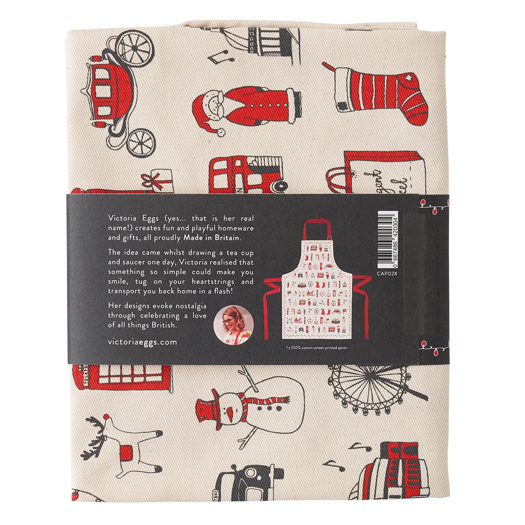 Children's London Christmas apron featuring repeating London landmarks, Kids kitchen apron featuring iconic London Christmas icons, Children's Christmas kitchen apron with red strap, Cotton Children's Christmas apron featuring ice skates and The London Ey