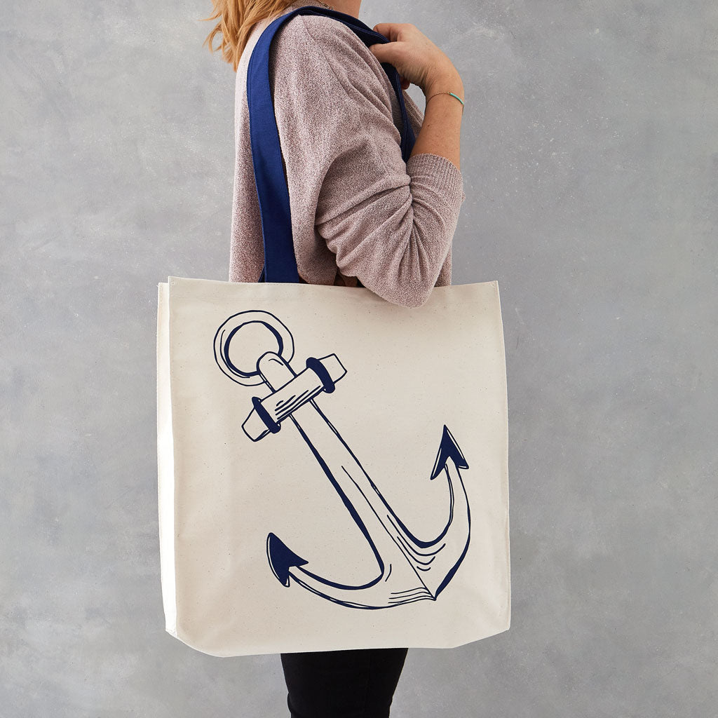 Double sided canvas bag featuring nautical design of an anchor and sailboat, Nautical canvas bag featuring both an anchor and sailboat design in navy, Reusable nautical bag featuring large anchor and sailboat design in navy