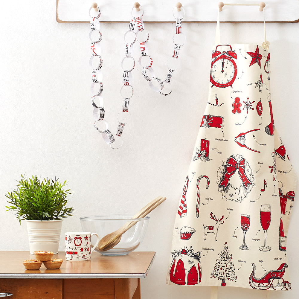 Christmas apron featuring traditional Christmas icons in red and charcoal, Unisex kitchen Christmas apron featuring Christmas designs, Women's Christmas apron with traditional Christmas designs, Men's Christmas apron with hand illustrated Christmas icons,