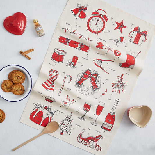 Christmas tea towel featuring repeating charcoal and red traditional Christmas icons, Christmas dish towel featuring iconic Christmas designs, Hand illustrated Christmas designs printed on a cotton tea towel, Christmas kitchen towel featuring Santa's slei