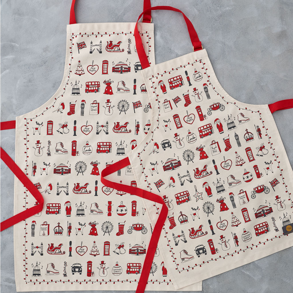 Set of two adult and children's aprons featuring iconic London landmarks, Charcoal and red child and Adult Christmas apron, Set of two adult and child apron with festive icons, Child and adult apron with ice skates and Christmas cookies 