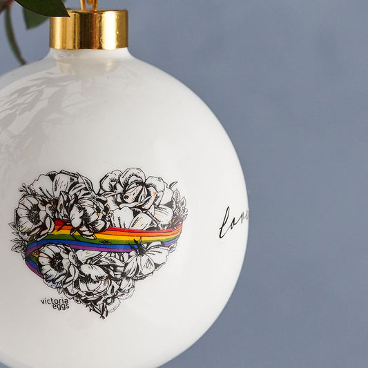 Love is Love, LGBTQ, Gay Pride bauble, decoration, ornament,, fine bone china, rainbow, heart, roses, hand decorated, made in Britain, Victoria Eggs. Rainbow, roses, heart shaped, illustration.