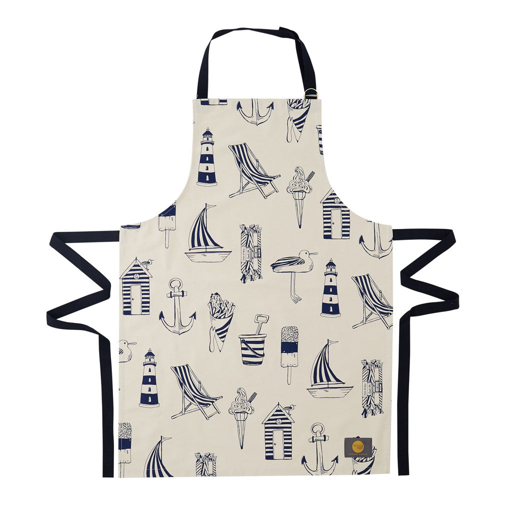 Kitchen apron featuring repeating design of navy nautical icons, Women's nautical apron featuring repeating navy design with beach chairs and sailboats, Men's nautical apron featuring repeating beach design in navy