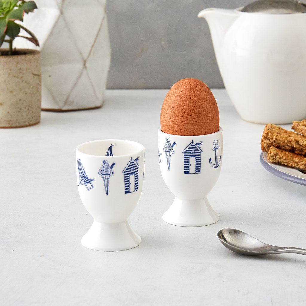 Nautical design egg cups featuring repeating pattern of navy nautical icons, Fine bone china egg cups featuring repeating nautical design, Navy and white nautical egg cups featuring hand illustrated nautical icons