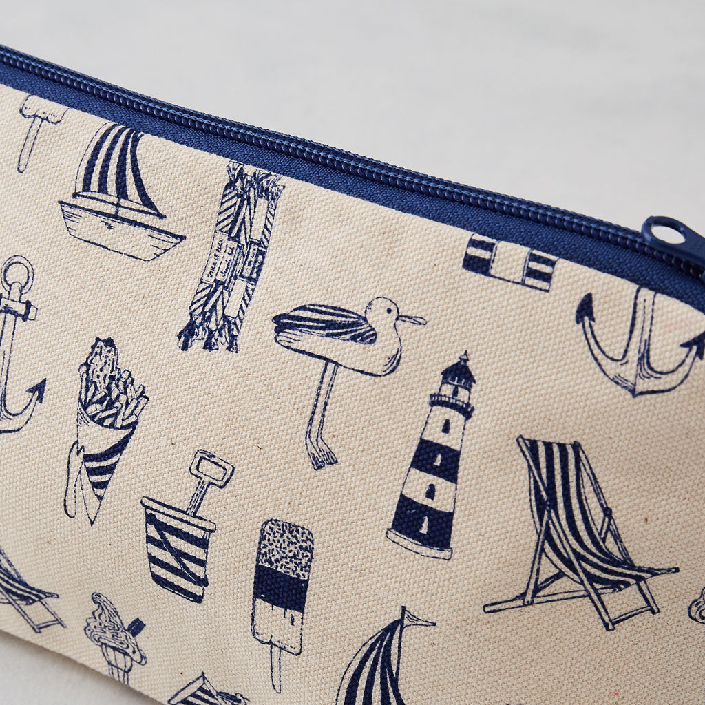 Cosmetic bag featuring repeating nautical design in navy, Pencil case featuring nautical design of repeating beachscape icons, Small nautical travel bag featuring repeating design of iconic nautical designs in navy