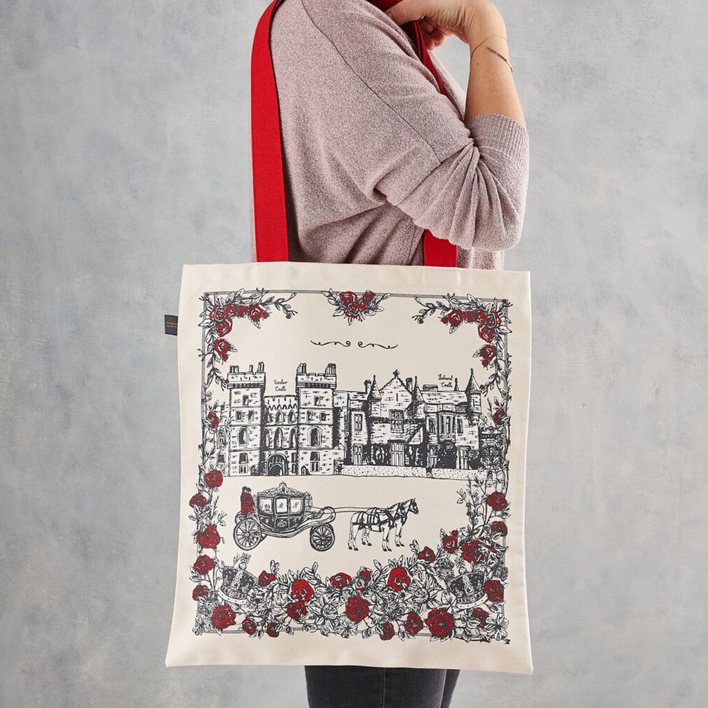 Canvas bag with Buckingham Palace design in charcoal and red, Canvas bag with red strap featuring Buckingham Palace, Canvas bag featuring iconic royal design, Charcoal and red canvas bag featuring hand illustrated royal icons