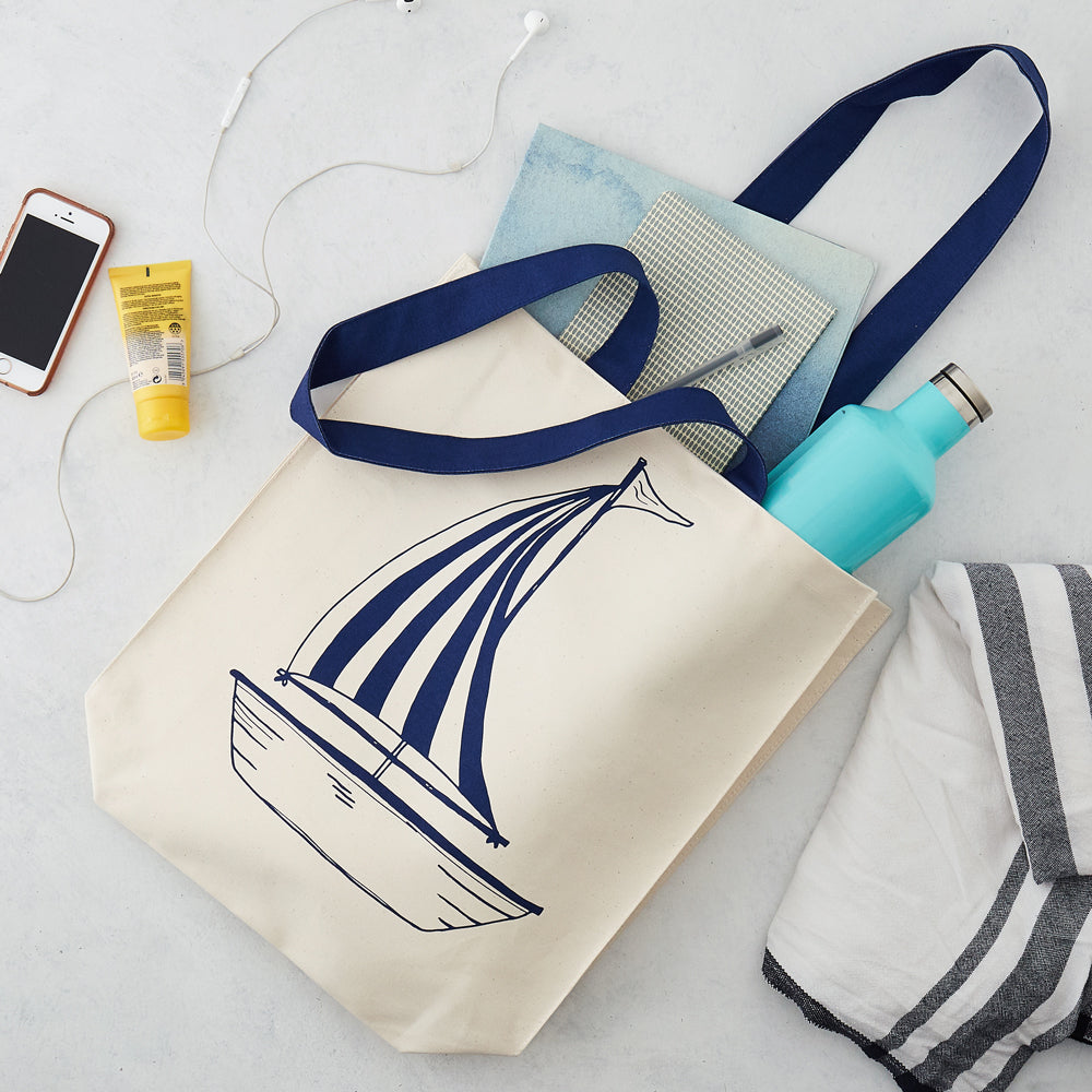 Double sided canvas bag featuring nautical design of an anchor and sailboat, Nautical canvas bag featuring both an anchor and sailboat design in navy, Reusable nautical bag featuring large anchor and sailboat design in navy